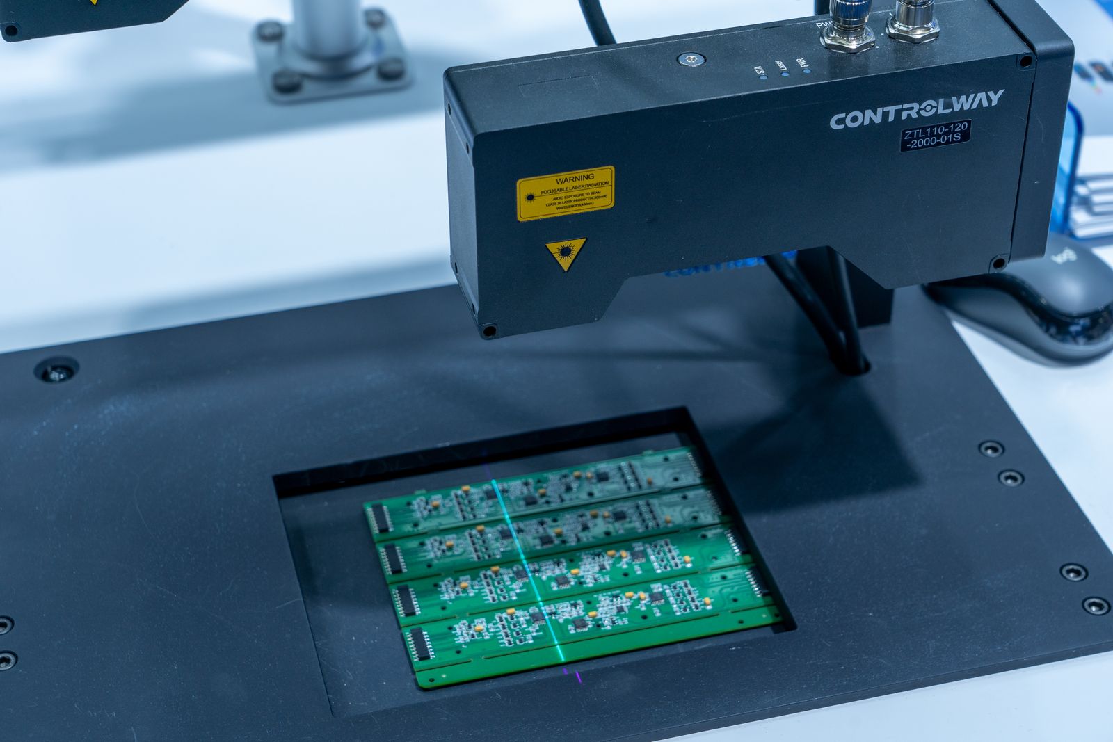 AI machine vision system optically inspecting circuit boards on a production line